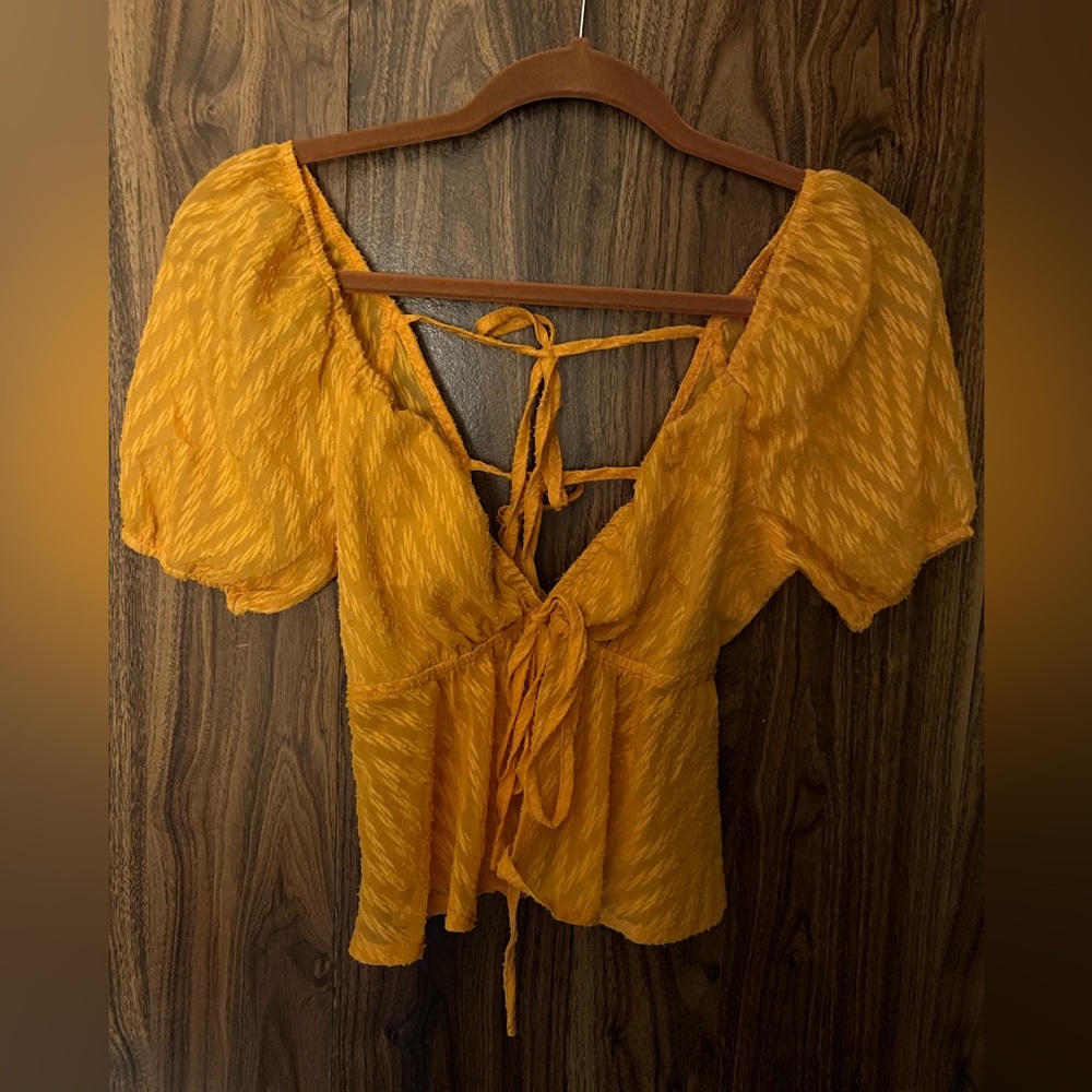 Orange short sleeve top with ties. Size small